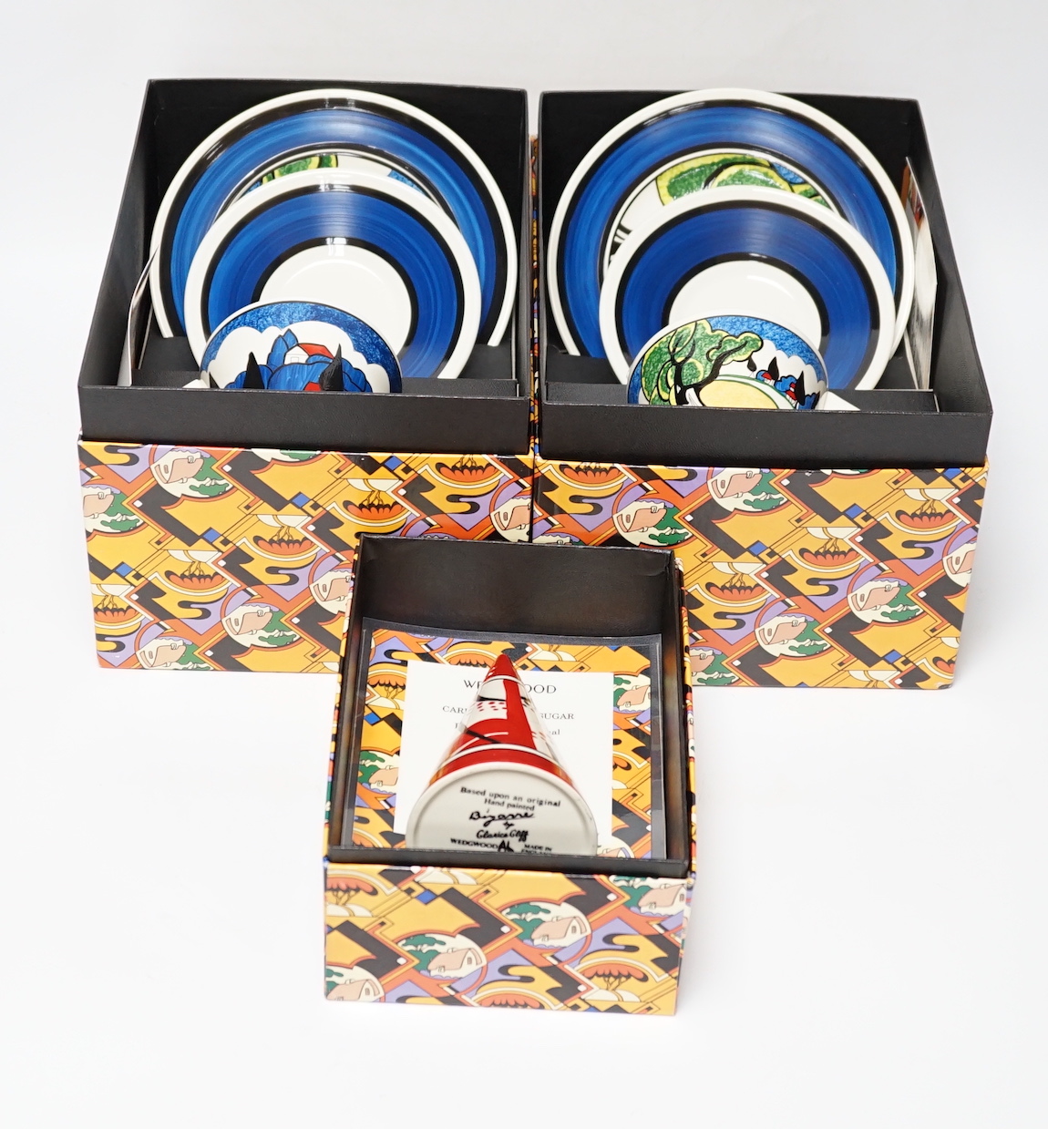 Two Wedgwood Clarice Cliff limited edition May Avenue trios together with a carpet conical sugar, each with boxes and certificates